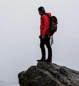 man on cliff edge looking out to the distance